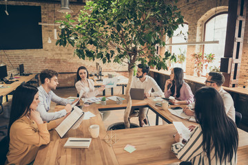 Photo of business people partners sit around table spacious office seven members successful new anti crisis crash plan professionals discussing observe graphics charts 2020 ending indoors