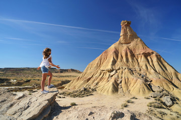 Young girl standing by Castildetierra, Bardenas Reales National Park