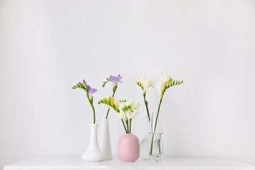 Beautiful spring freesia flowers on white table