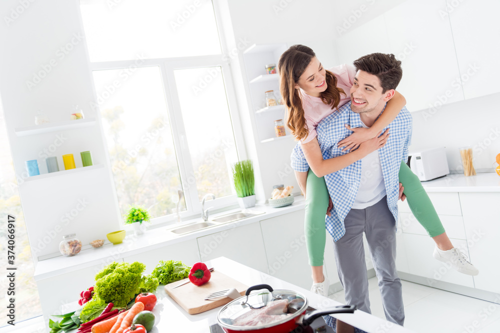 Sticker Two people funky spouses passionate man carry piggyback girl enjoy hobby weekend dinner supper lunch preparation hug in kitchen house indoors