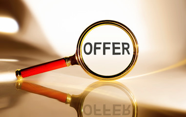 OFFER concept. Magnifier glass with text on white background in sunlight.