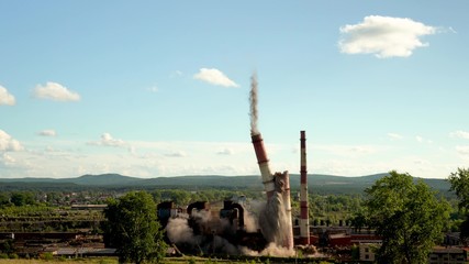 The collapse of an industrial chimney. Explosion of an old chimney of an obsolete metallurgical plant.