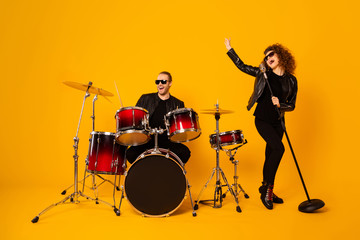 Full length photo of rock group guy play instruments beat drum sticks crazy attractive star redhair...