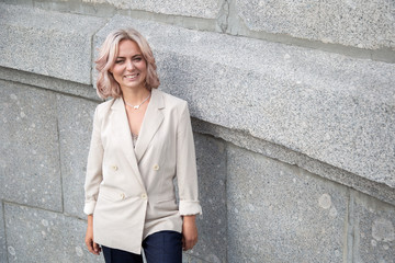 Portrait of a young woman in a business suit in the city