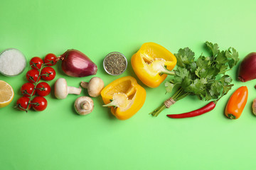 Flat lay composition with ingredients for cooking on green background
