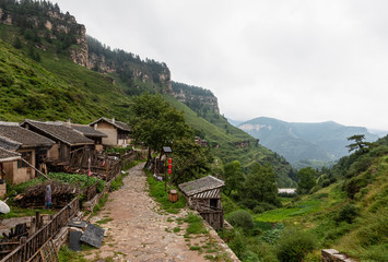 Stilted walkway at ancient Xuankong (hanging) or Wanghuagou Village built between cliffs in Mount Guancen of Luya Mountains, Ningwu County, Xinzhou, Shanxi, China. Altitude of 2300 meters.