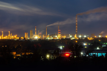 oil refinery lights against the night sky