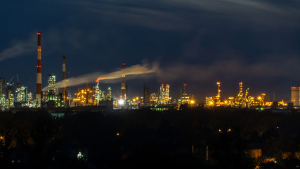 oil refinery lights against the night sky