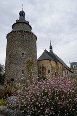 old castle and church in a small town in France with spring flowers