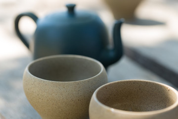 Chinese tea ceremony. Ceramic teapot made of clay and bowls on a wooden background.