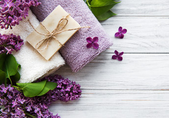 Obraz na płótnie Canvas Spa towels and soap and lolac flowers