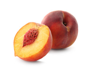 Fototapeta na wymiar Whole and cut ripe peaches isolated on white