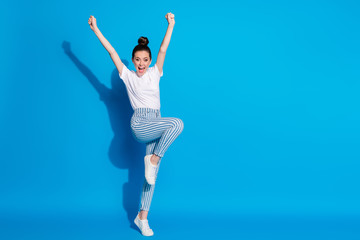 Fototapeta na wymiar Full length body size view of her she nice attractive pretty cheerful cheery girl jumping rejoicing celebrating holiday having fun leisure isolated on bright vivid sine vibrant blue color background