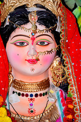 Fototapeta na wymiar Sculpture of Hindu Goddess Durga, Goddess Durga idol with ornaments in close up side face view