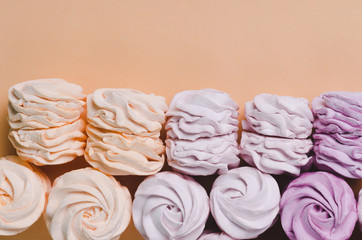 colorful marshmallows on yellow background. Color sweet homemade zephyr or marshmallow. Flat lay....