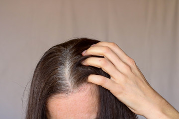 Fototapeta premium Middle aged woman Serious and Stressed effected to headache and gray hair on white background