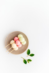 Japanese Dango dessert in pink, white and green colors, copy space