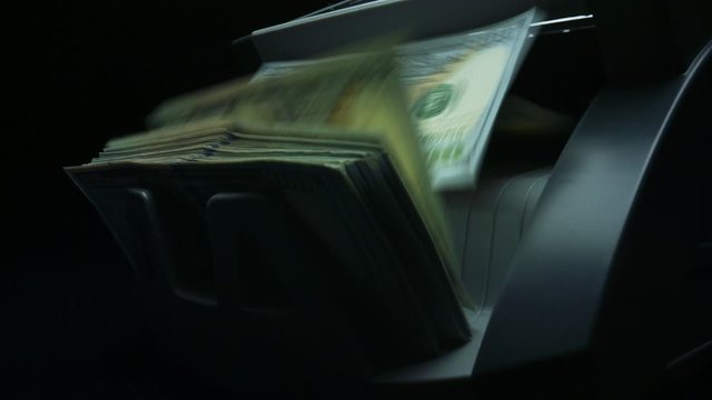 Money counting machine. Counting dollar banknotes in currency counter machine