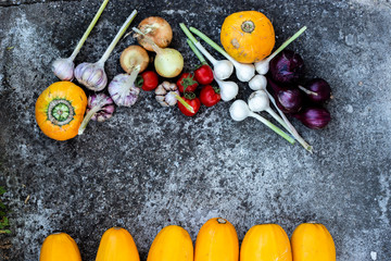 Fresh organic food border or frame - seasonal vegetables. Dark gray textured background with copy space. Photo top view