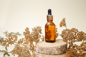 Dropper glass bottle skincare essential oil products for mock up in minimal style with on pastel cream background