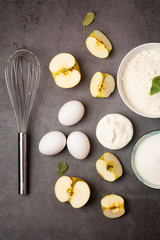 ingredients for apple pie on dark background top view.