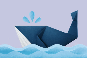 Photo of paper origami marine blue whale in waves on violet background