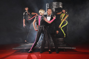 Fototapeta premium Magician performer and beauty girls show trick with box illusion on the ring in circus