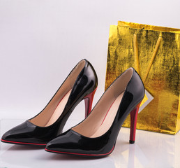 Classic patent women's high-heeled shoes on a white background.