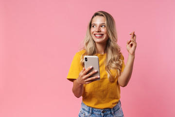 Positive young woman using mobile phone