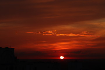 The sun is approaching the horizon. Sunset in the evening city