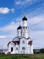 White Church of Vladimir Equal of the Apostles in the village of Burmistrovo In Siberia, in Russia in summer. Christian religion, Orthodox church. vertical. Mobil photo.