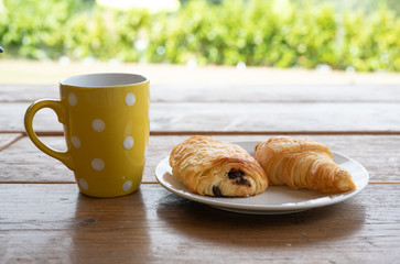 Croissants and coffee for breakfast outside