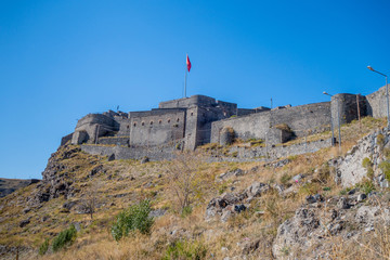 View on main buildings of Kars Castle, Kars, Turkey. Citadel located on unattackable rock, surrounded by walls made from basalt bricks. Fortifications built in 1153. Now it's main attraction in city