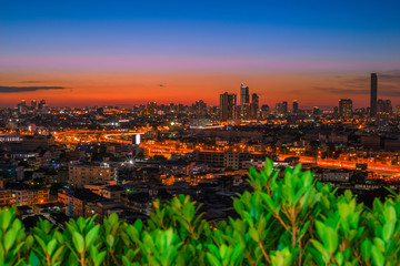 abstract background of the green leaves in the park,with the blur of bokeh,the light from the colorful shelter falling onto,a kind of artistic beauty of nature