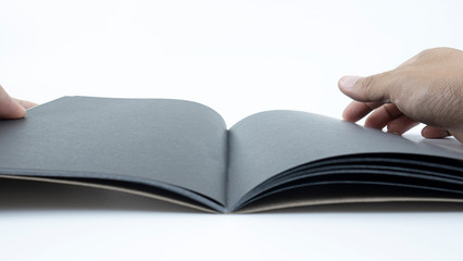 Close up handle black paper pages flipping on white background..