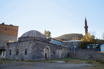 Fototapeta na wymiar Ancient bath house, called Mazlum Aga Hammam, Kars, Turkey. It's built in 18 century in typical Osman style: rectangular layout, spherical domes. Material of building is basalt