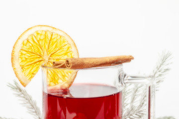 Mulled wine in a glass with a set for mulled wine on a white background.