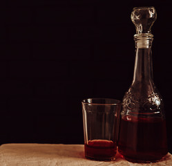 glass retro decanter and glass on table with red drink