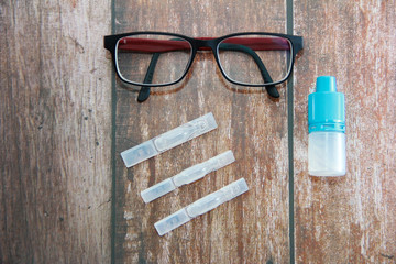 eye drops in ampoules and red a rimmed glasses