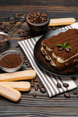 Obraz na płótnie Canvas Classic tiramisu dessert and savoiardi cookies on ceramic plate on wooden background