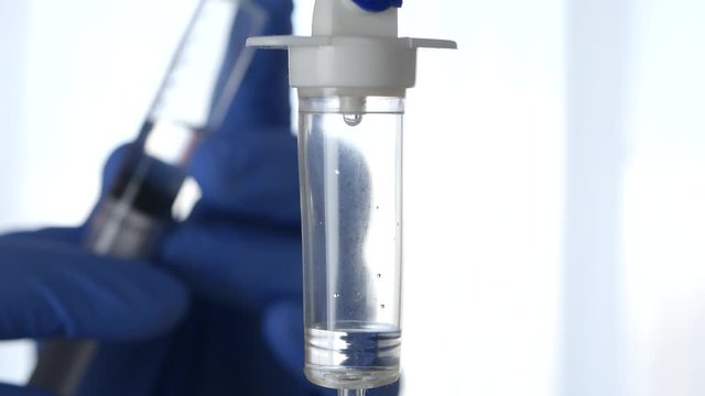 Medical Perfusion and the Hand of a Paramedic in Blur Using an Injection in a Hospital