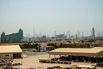 Naklejka premium View of not a usual Dubai's skyline with warehouse on foreground. UAE.