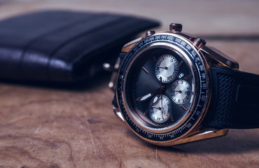 Business wristwatch on the wooden table