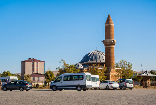 Square near bus station on route 'Kars-Van' in eastern Turkey. There are some minibuses (so called Dolmush in Turkish), & brick mosque with minaret called Otogar Mosque