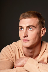 Thoughtful handsome young man posing in studio