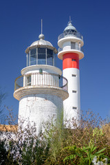 Two lighthouses together on the Spanish coast. The ancient and the modern together. Sunny day in El Rompido, Huelva, Andalusia, Spain