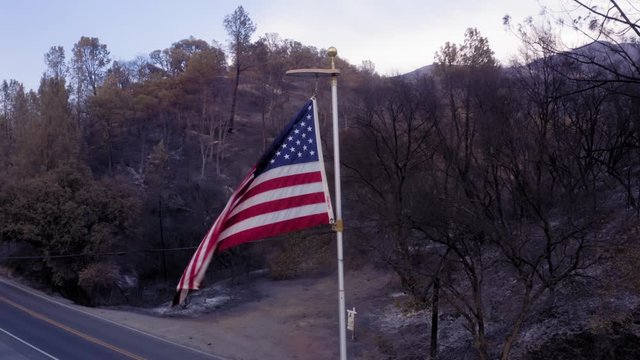 Napa, California, USA. 22 August 2020. Aerial: Road & burnt american flag. LNU Lightning Complex Fire that ravaged the Napa, Sonoma, Lake and Solano counties.