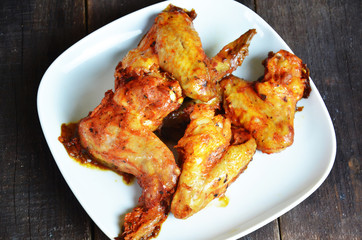 appetizing toasted plate of chicken wings on brown wooden table Crispy Buffalo Chicken Wings baked. Cafe Delites takeaway, restaurant or cafe menu