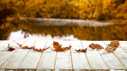 Autumn lake and wooden table of free space 