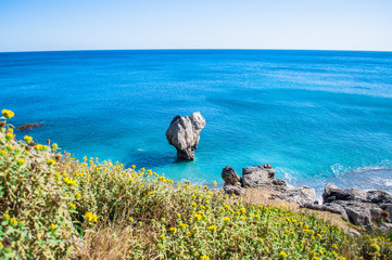 Preveli beach on Crete island with clear water, Greece, Europe. Stone on the sea with heart shape, waves and rocks around. 